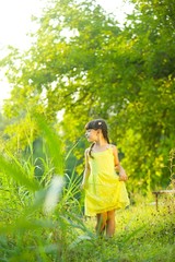 Baby girl in bright yellow dress