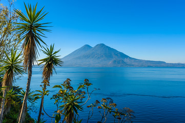 View from Lake Atitlan in the early morning, blue skys and clear water, beautiful magic lake with...