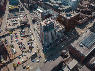 Obraz premium Aerial city centre drone above buildings british manchester skyline summer blue sky ancoats northern quarter