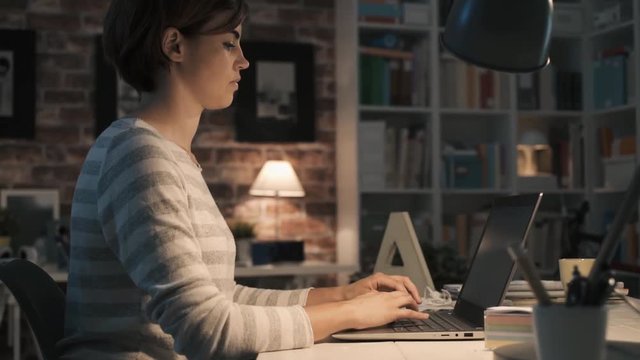 Woman working with her laptop at home