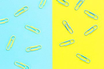 Yellow and blue paper clips on a blue and yellow background