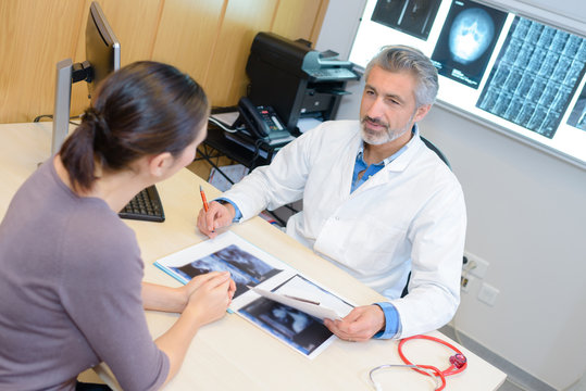 Specialist discussing xrays with patient
