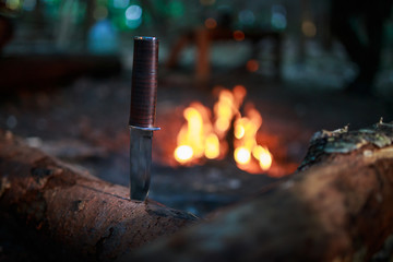 knife in wood by fire