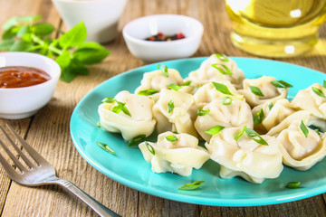 Homemade ready dumplings on an old wooden table.