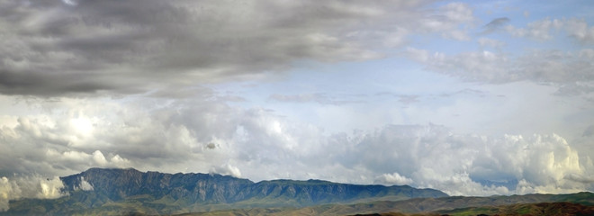 before thunderstorm in mountains / landscape with scene storm sky in mountains Uzbekistan