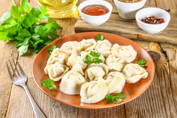 Homemade ready dumplings on an old wooden table.