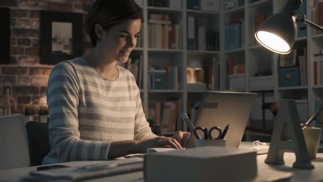 Woman chatting with her laptop at home