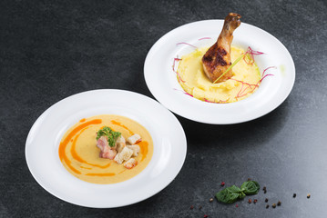 Complex dinner. Mashed potatoes with chicken leg appetizing on a white plate