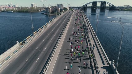 4K Aerial drone fooage. Marathon running on the bridge.