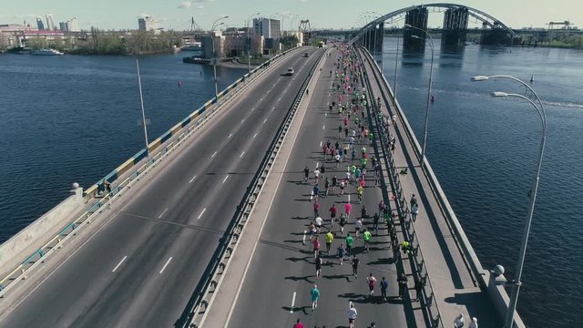 4K Aerial drone fooage. Marathon running on the bridge.