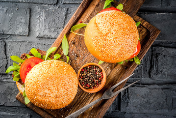 Homemade bbq beef meat sandwich burger with fresh vegetables copy space dark background above