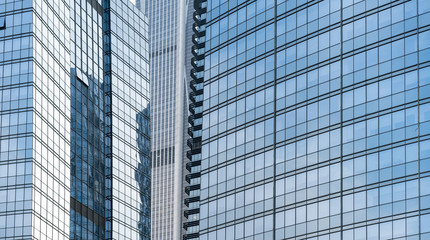 modern office building with reflection in windows of building