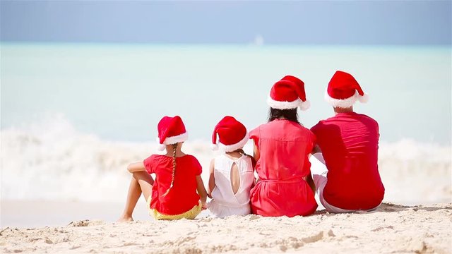 Happy family with two kids in Santa Hat on Xmas vacation