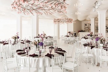 Photo of beautiful white wedding hall with big tables isolated