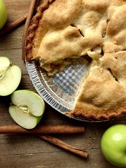 Apple pie on a wood surface, overhead view
