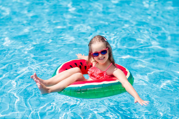 Child in swimming pool. Kids swim. Water play.