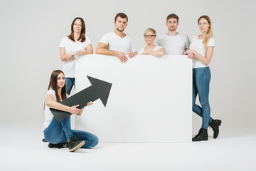 Serious group of friends posing with a white board