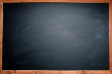 Chalk rubbered out on blank blackboard around with wooden frame for background