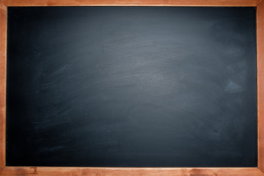 Chalk rubbered out on blank blackboard around with wooden frame for background