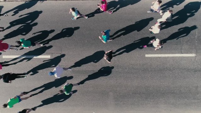 4K Aerial drone fooage. Marathon running on street. Top view close up