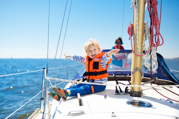 Kids sail on yacht in sea. Child sailing on boat. - obrazy, fototapety, plakaty