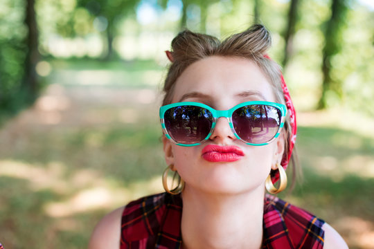 Group of friends at park having fun party. Rockabilly hen-party in park. Portrait of girl