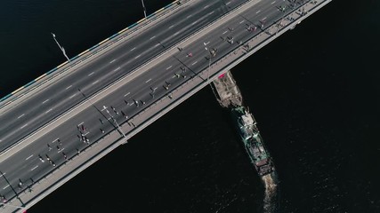 4K Aerial drone fooage. Marathon running on the bridge. Ship under bridge