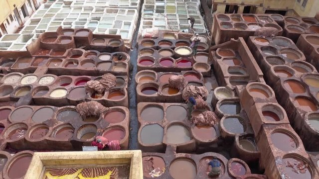 Tanneries in Fes, Morocco, Africa. Old tanks with color paint for leather, 4k