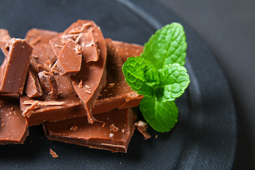 Chocolate on dark stone background. Top view with copy space.