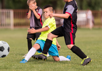 Obraz premium Young children players football match on soccer field