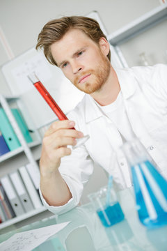 Scientist holding a graduated cylinder