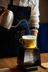 Bartender Hand drip coffee , Barista pouring water on coffee ground with paper filter