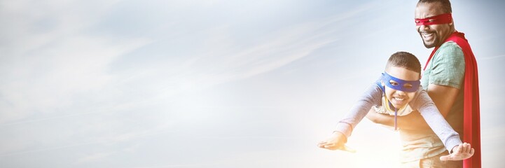 Composite image of father and son pretending to be superhero © vectorfusionart