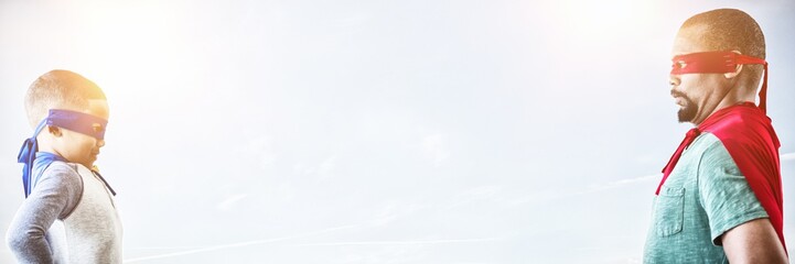 Composite image of father and son pretending to be superhero