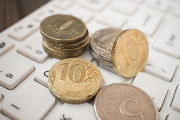coins on the laptop keyboard