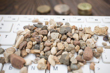 campy on a white keyboard, next to the coins lie