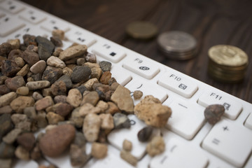 campy on a white keyboard, next to the coins lie