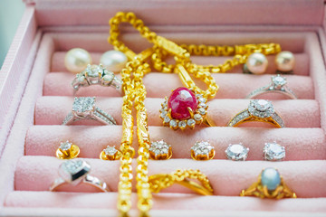 Gold and silver diamond gemstone sapphire ring necklaces and pearl earrings in luxury jewelry box