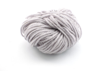 Ball of gray yarn on white background.