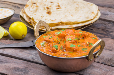 Indian Delicious Cuisine Paneer Tikka Masala With Tandoori Chapati Also Called Paneer Butter Masala is an Indian Dish of Marinated Paneer Cheese Served in a Spiced Gravy on Wooden Background