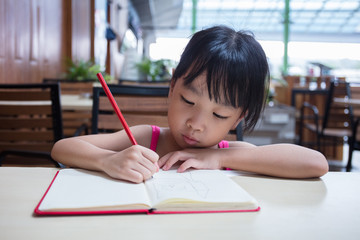 Asian Chinese little girl doing homework