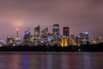 Fototapeta na wymiar Sydney at dusk with skyscapers illuminated in Australia.