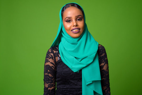 Young African Muslim woman against chroma key with green background