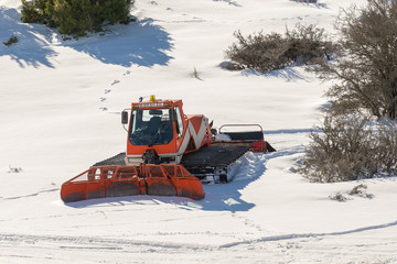 Snowplow truck against the snow.