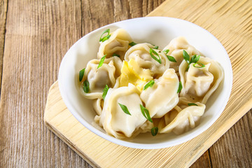 Homemade ready dumplings on an old wooden table.