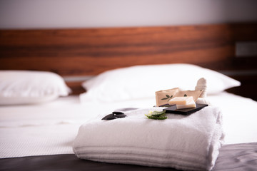 Towels set in hotel bedroom