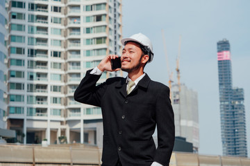 Smart Engineering talking on phone and working at outdoor,happy Teamwork concept.