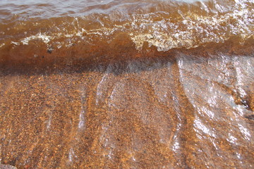 the texture of the water is orange in color bubbles foam background abstraction coming wave