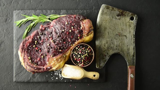 Marbling ribeye steak on black plate. Prime rib beef chop