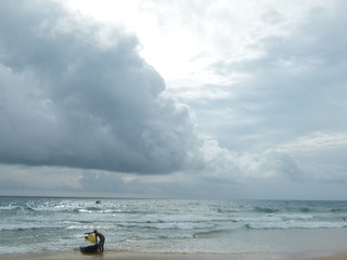 The man with his jet ski on the beautiful beach and among the clouds of Patong beach, Phuket.